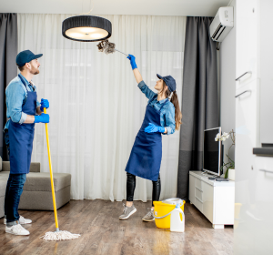 Cleaners cleaning and dusting a living room