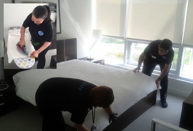 Workers cleaning a guest suite in a condominium